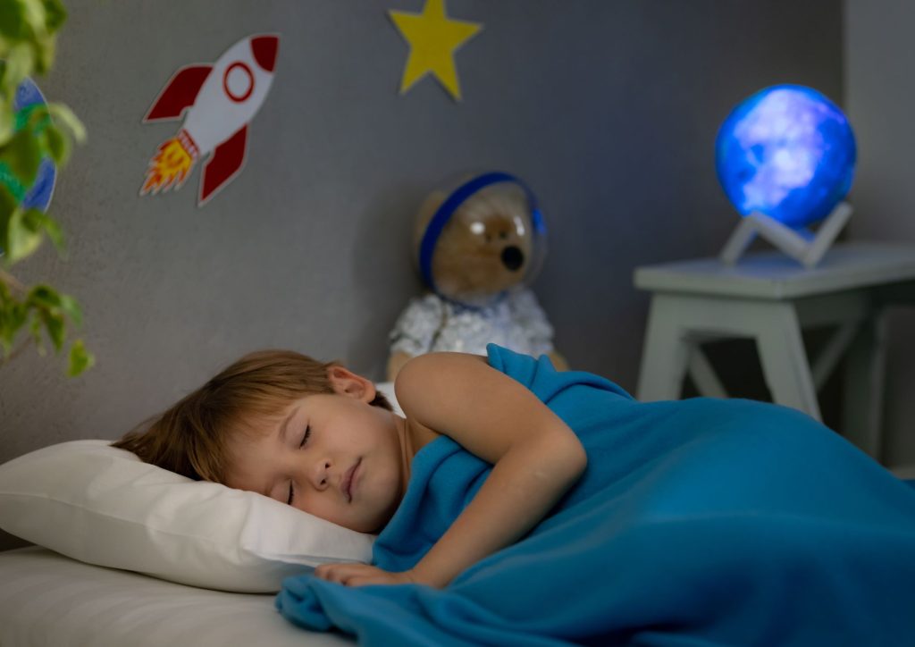 Enfant qui utilise une veilleuse pour ne pas avoir peur du noir